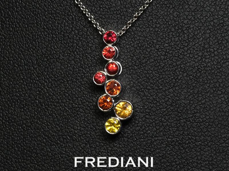 Pendentif  en or blanc 750/000 serti de 8 saphirs jaunes à rouges ronds traités.