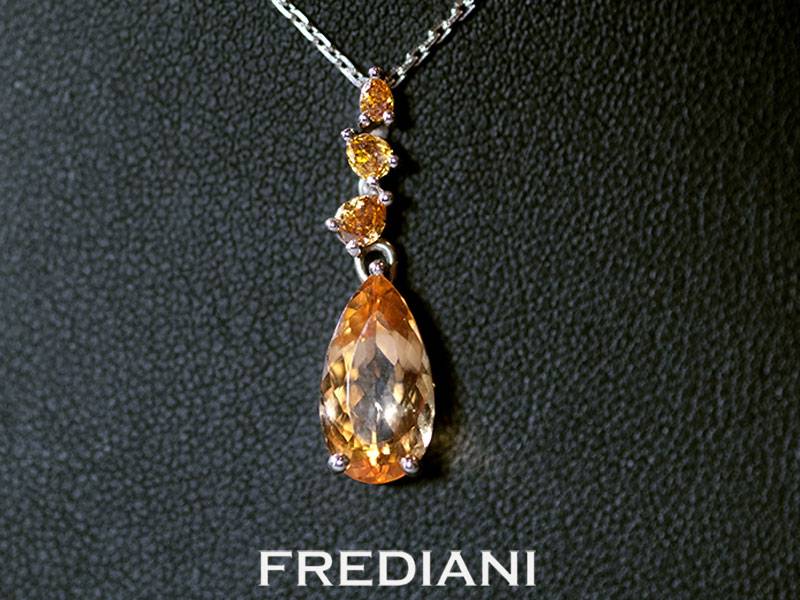 Pendentif en or blanc 750/000 serti d'une topaze impériale poire et 3 diamants jaunes naturels