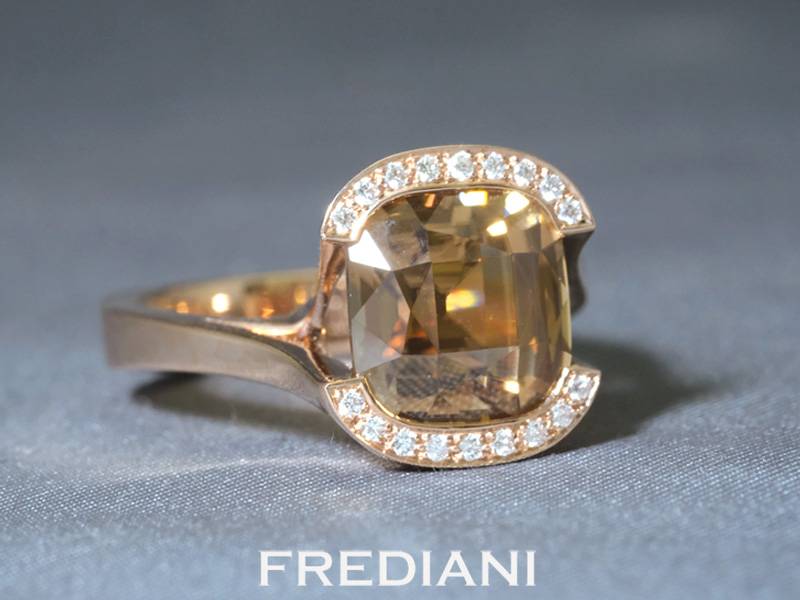 Bague en or rouge 750/000 sertie d'un zircon brun naturel coussin accompagné de 18 diamants.